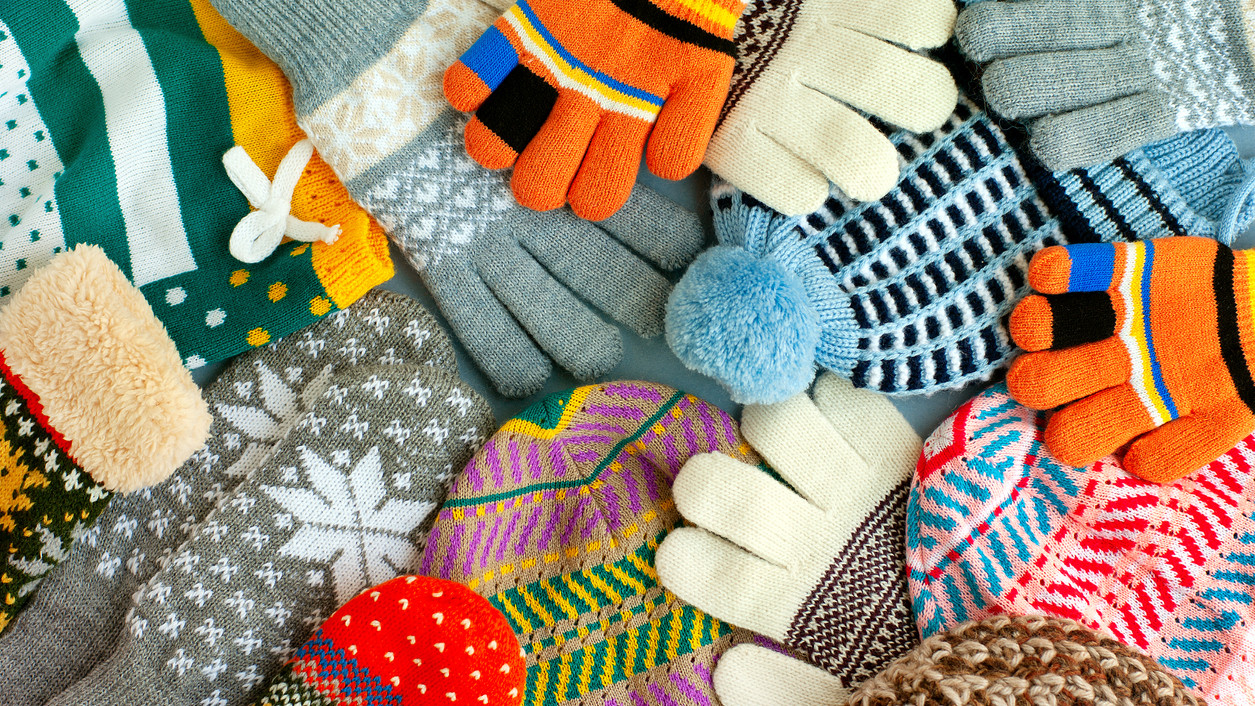 Colorful warm clothes in the form of hats, gloves and mittens.